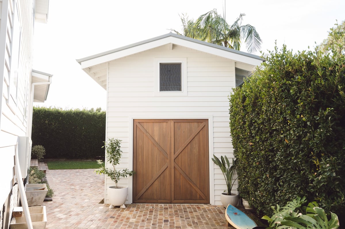 Garage with hedges by ACG Built
